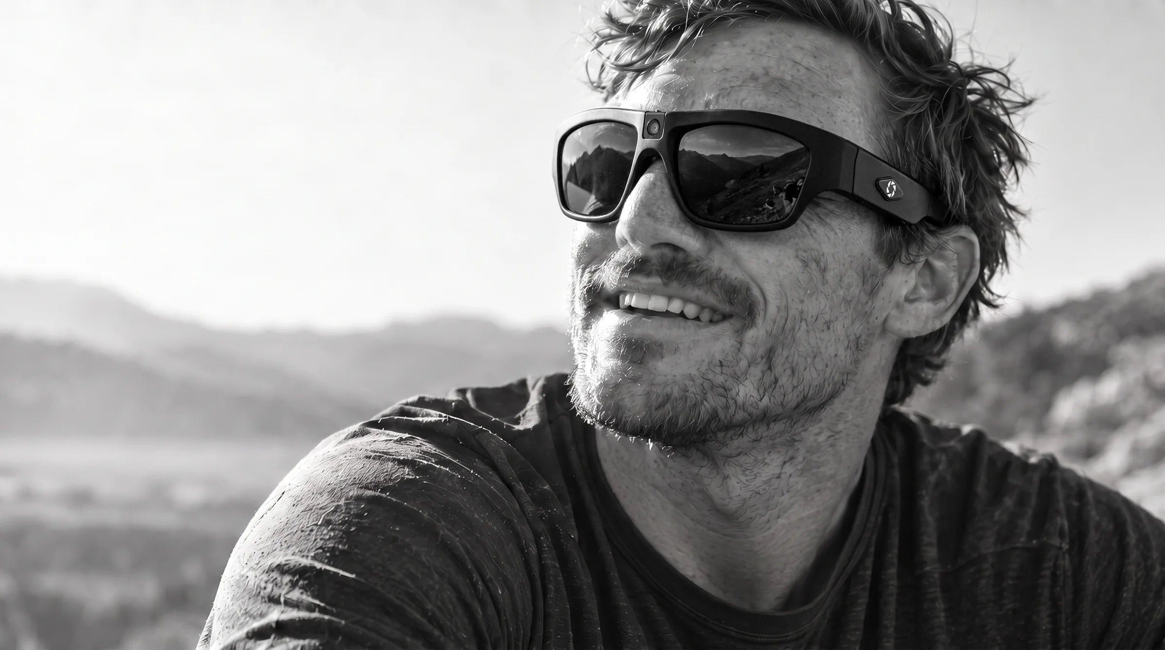 A smiling man outdoors wearing the Denali
